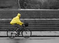Bicyle in rain with yellow poncho