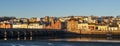 BIDEFORD, DEVON, ENGLAND - JANUARY 13 2022: First rays of the sun on Bideford, with the ancient Long Bridge.