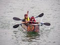 BIDEFORD, DEVON, ENGLAND - JULY 24 2022: Participant in annual Water Festival Cardboard Boat Race, River Torridge. Rainy