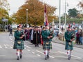 BIDEFORD, DEVON, ENGLAND - NOVEMBER 14 2021: Remembrance Sunday ceremony. Bagpipe players lead local dignitaries to the