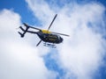 BIDEFORD, DEVON, ENGLAND, UK - MAY 11 2020: A blue and yellow police helicopter patrols the skies of north Devon.