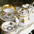 Victorian antique porcelain coffee service in gold and white Royalty Free Stock Photo