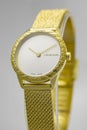 Biel, Switzerland 31.03.2020 - The closeup of CALVIN KLEIN woman watch stainless steel case gold PVD coating white clock