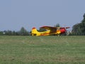 Side of beauty Yakovlev Yak-12M SP-AWG airplane lands on green grassy airfield in european Bielsko-Biala city in Poland