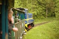 The Bieszczady Forest Railway. A view of a locomotive pulling wagons in the forest