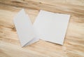 Bifold white template paper on wood texture.