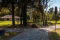 Bifurcation in a cobblestone park path with a broken, rusty and grungy street semaphore