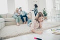 Big adopted family little girl lying floor fluffy carpet ending drawings while parents enjoy watching son`s art Royalty Free Stock Photo