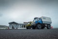 Big adventure truck with large off road tires are parked in front of a store with gas station in iceland. Overlanding through Royalty Free Stock Photo