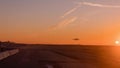 The big airliner landed on the sunset track, the backlit aircraft in orange and golden tones. Royalty Free Stock Photo