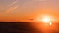 The big airliner landed on the sunset track, the backlit aircraft in orange and golden tones. Royalty Free Stock Photo