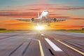 Big airplane in motion take off the evening sky sunset sunrise sun airport Royalty Free Stock Photo