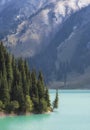 Big Almaty Lake in Tien Shan mountains of Kazakhstan. a Panorama of Beautiful mountain landscape on a fall evening with first snow Royalty Free Stock Photo