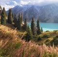 Big Almaty Lake in Tien Shan mountains of Kazakhstan. Panorama of Beautiful mountain landscape on a fall evening with white first Royalty Free Stock Photo