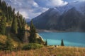 Big Almaty Lake in Tien Shan mountains of Kazakhstan. a Panorama of Beautiful mountain landscape on a fall evening with white Royalty Free Stock Photo