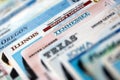Big amount of driving licenses from various USA states. Stack of driving license specimen Royalty Free Stock Photo