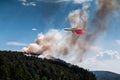 Big amphibious fire aircraft drops water on forest fire Royalty Free Stock Photo