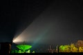 Big antenna of the radio telescope illuminated by green light