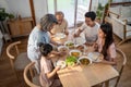 Big Asian happy family spend time having lunch on dinner table together. little kid daughter enjoy eating food with father, mother