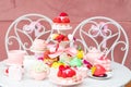 Big assortment of pink sugar dessert treats on white table in cafe or candy shop. Holiday celebration with tasty food Royalty Free Stock Photo