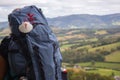 Big backpack with pilgrim shell on mountain background. Pilgrimage concept. Pilgrim on Camino de Santiago road.