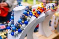 Big beads on a mannequin. Bright feminine decoration in blue and white. Selling colorful necklaces on the counter