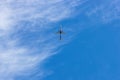 Big beautiful blue and white plane flying in the cloudy blue sky Royalty Free Stock Photo