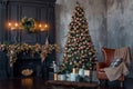 Big beautiful Christmas tree decorated with golden and beige shiny baubles and many different presents. Illuminated fir Royalty Free Stock Photo
