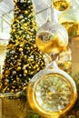Big beautiful Christmas tree decorated with ornaments golden silver hanging balls bows garland sparkling lights in european city Royalty Free Stock Photo