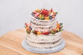 Big beautiful and delicious cake with strawberries, blueberries and tangerines. Royalty Free Stock Photo