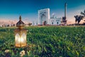 A big beautiful Mosque with green grass and islamic lantern