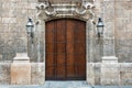 big beautiful ornate wooden door, framed by a decorated stone arch - entrance to a gothic cathedral or castle Royalty Free Stock Photo