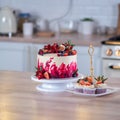 Big beautiful red velvet cake, with flowers and berries on top. Delicious sweet muffins with cream, Royalty Free Stock Photo