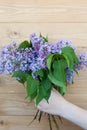 Big beautiful spring bouquet of lilacs in woman hand. Lilac flowers