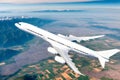 A big beautiful white liner flying over the ground Royalty Free Stock Photo