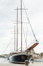 Big beautiful wooden yacht with sails moored to the shores of Cr