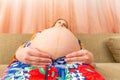 Big belly of a pregnant woman, bottom view wide-angle photo