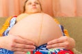 Big belly of a pregnant woman, bottom view wide-angle photo