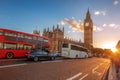 Big Ben with buses on the bridge against colorful sunset in London, England, UK Royalty Free Stock Photo