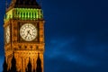 Big Ben clock face at night with silhouette of Houses of Parliament in foreground Royalty Free Stock Photo