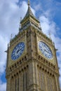 Big Ben clock set against partially cloudy blue sky. London Landmark