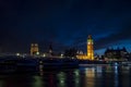 Big Ben and the Houses of Parliament at night from across the river Thames and Westminster bridge southbank in London, England, UK Royalty Free Stock Photo