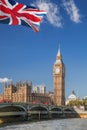 Big Ben and Houses of Parliament with red buses on bridge in London, England, UK Royalty Free Stock Photo