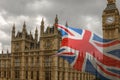 Big Ben in London and UK Flag waving Royalty Free Stock Photo