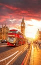 Big Ben with red bus against colorful sunset in London, England, UK Royalty Free Stock Photo