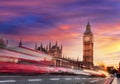 Big Ben with red bus against colorful sunset in London, England, UK Royalty Free Stock Photo