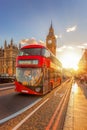 Big Ben with red bus against colorful sunset in London, England, UK Royalty Free Stock Photo