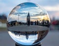 Big Ben seen inside a crystal ball upside down tourists in the background Royalty Free Stock Photo