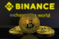 A big Bitcoin cryptocurrency coin in the centre and other bitcoin coins from both side in front of Binance crypto market . The