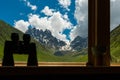 Binoculars lying on sill overlooking mountain. Royalty Free Stock Photo